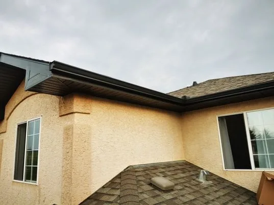Brown eavestrough on a stucco home